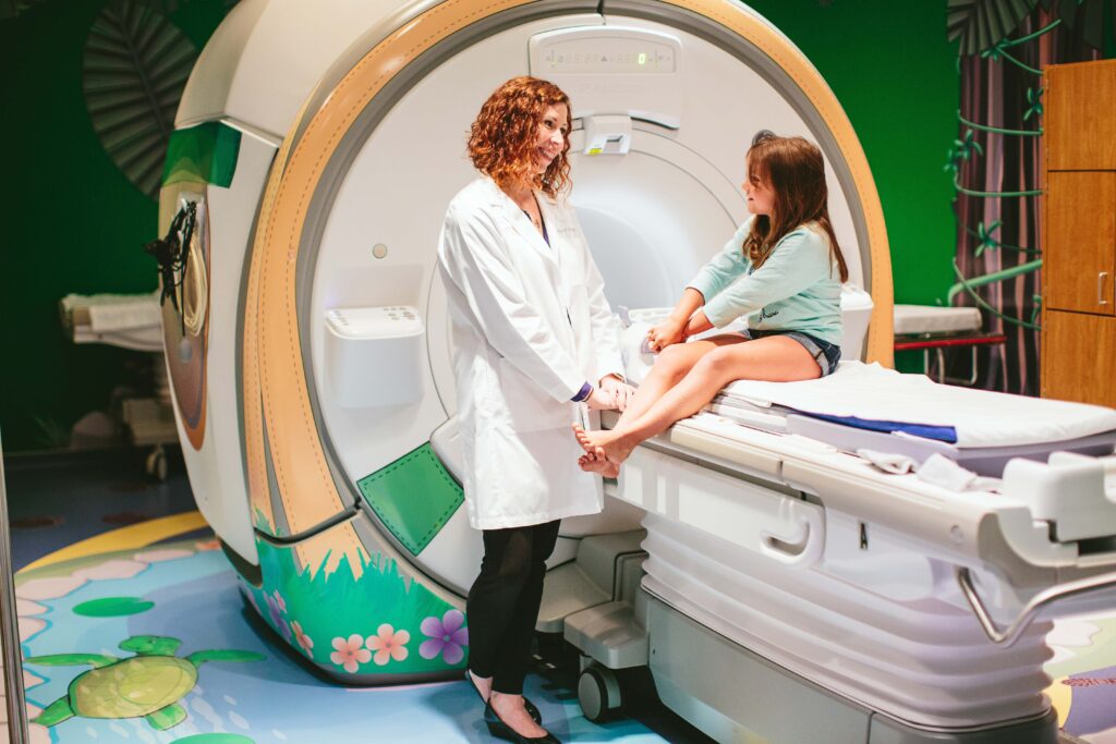Girl sitting on MRI table